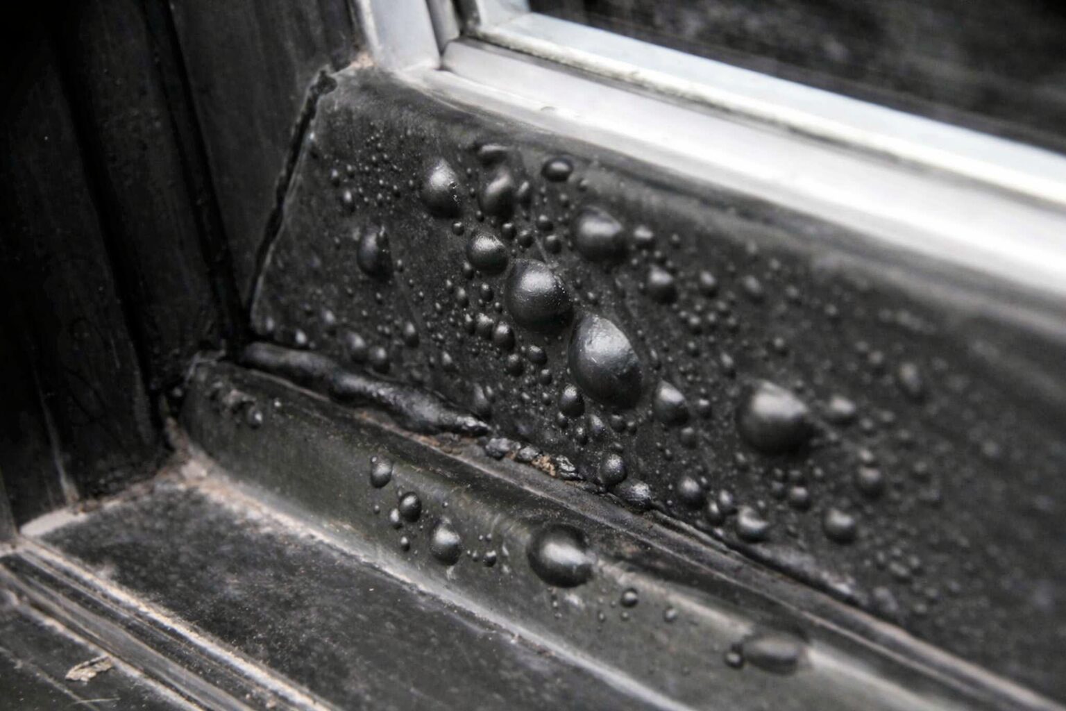 Failed vinyl window paint showing bubbling and blistering from using wrong paint type on vinyl frames