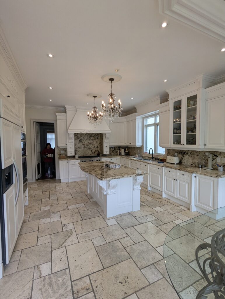 freshly painted white kitchen cabinets with smooth satin finish, modern hardware, and clean backsplash after professional kitchen cabinet painting